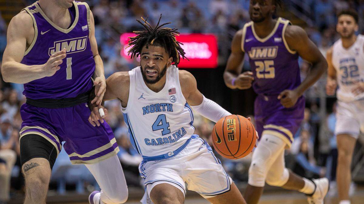 North Carolina’s R.J. Davis (4) drives against James Madison’s Noah Freidel (1) in the first half on Sunday, November 20, 2022 at the Smith Center in Chapel Hill, N.C.