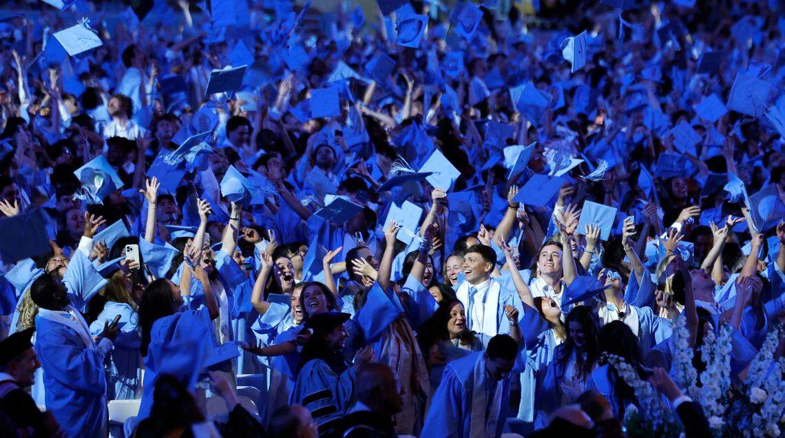 UNC graduates toss their mortar boards into the air at the conclusion of UNC Chapel Hill’s commencement ceremonies at Kenan Stadium in Chapel Hill, N.C., Saturday, May 11, 2024.