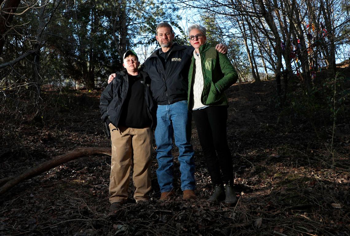 Martha Browne, right, poses with David Marshburn and Marsha Ward, private investigators, January 25, 2019, The three are standing near the site by Martin Middle School in Raleigh where Marshburn and Ward found Martha’s son Drew’s body more than four years after he went missing.