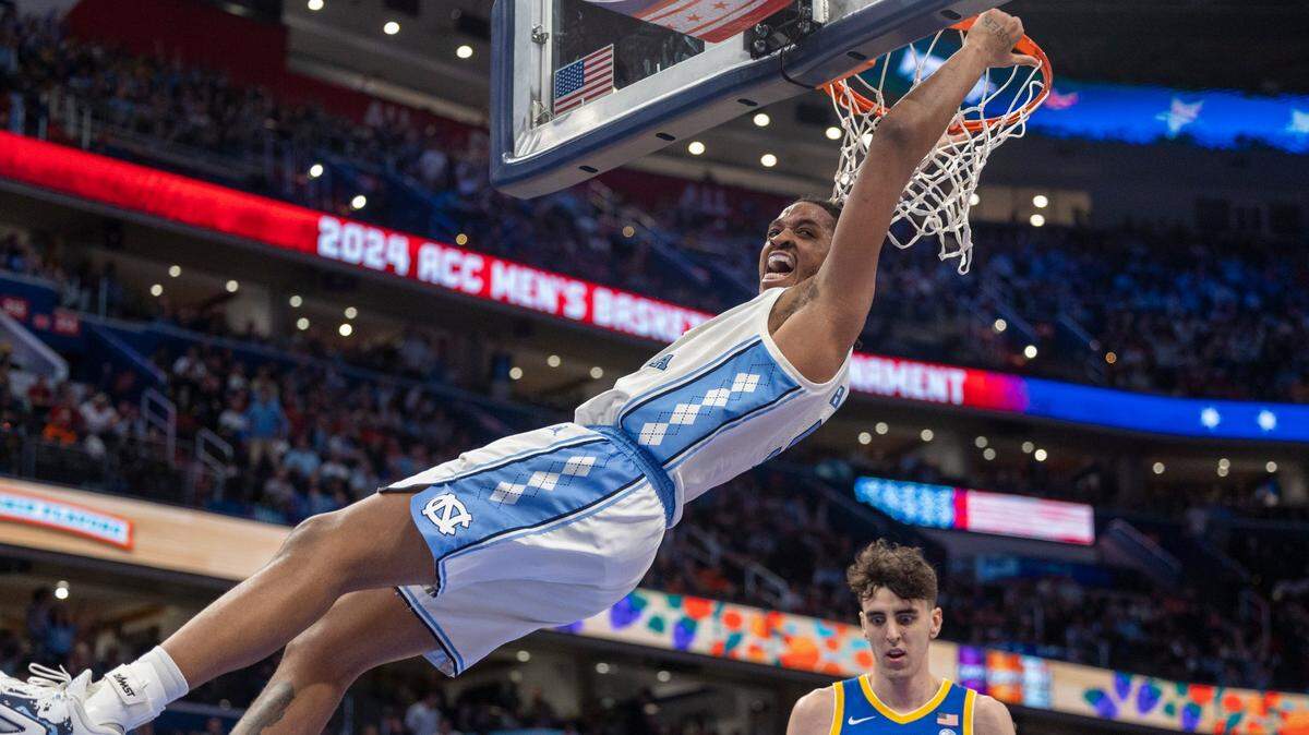 North Carolina’s Armando Bacot (5) hangs on the rim after a dunk over Pittsburgh’s Guillermo Diaz Graham (25) during the second half in the semi-finals of the ACC Men’s Basketball Tournament at Capitol One Arena on Friday, March 15, 2024 in Washington, D.C. Bacot scored 19 points in the Tar Heels’ victory. 
