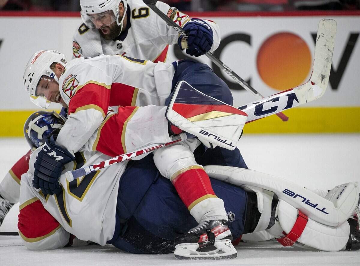 The Florida Panthers Gustav Formling (42) piles atop goalie Sergei Bobrovsky (72) as they celebrate their 3-2 victory over the Carolina Hurricanes in four overtimes, after a goal by Matthew Tkachuk, during Game 1 of the Eastern Conference Finals on Friday, May 19, 2023 at PNC Arena in Raleigh, N.C.