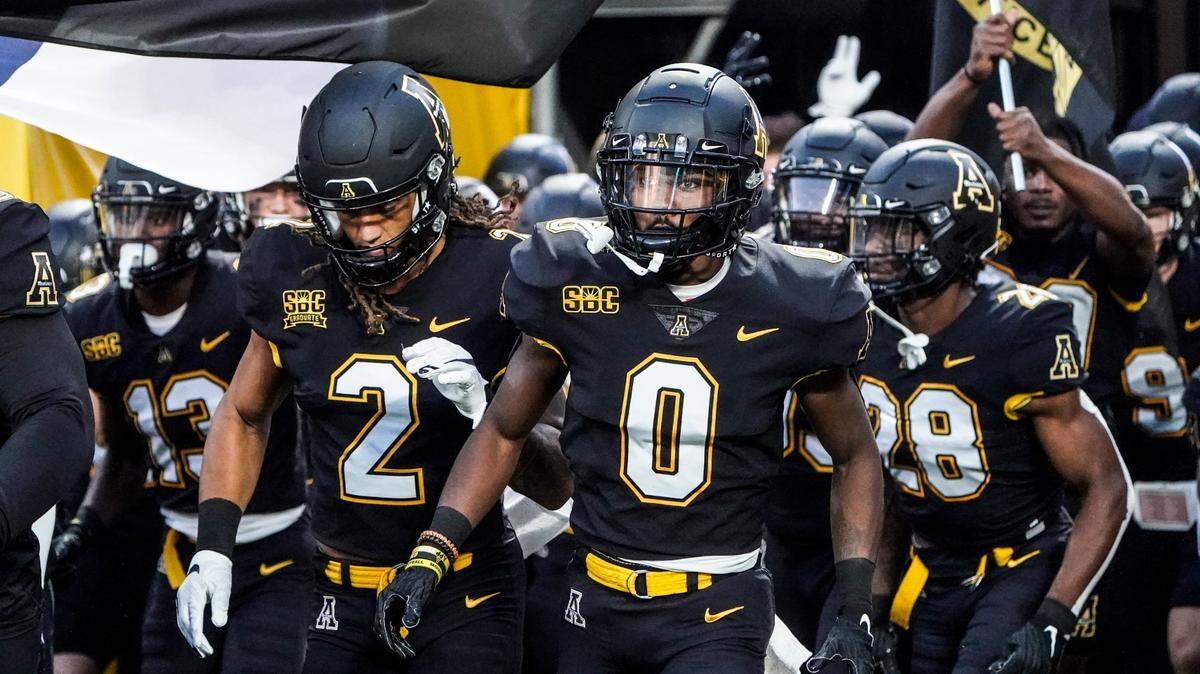 Appalachian State players run onto the field at the Duke’s Mayo Classic at the Bank of America Stadium in Charlotte, N.C., on Thursday, September 2, 2021. The Mountaineers host North Carolina, Saturday, Sept. 3, 2022.