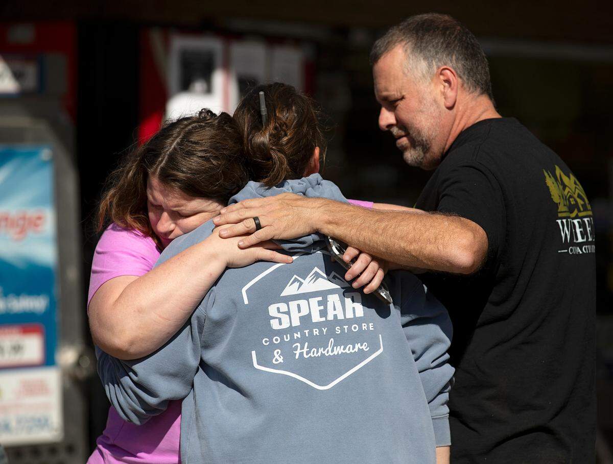 Heather Bender, left, offers an embrace outside Spear Country Store & Hardware as community members gather on Thursday, Oct. 3, 2024, in Newland, N.C., days after Hurricane Helene brought heavy flooding to the region.