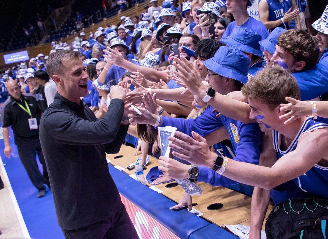 Duke head coach Jon Scheyer is congratulated by students following the Blue Devils’ win over Jacksonville on Monday, Nov. 7, 2022, at Cameron Indoor Stadium in Durham, N.C.