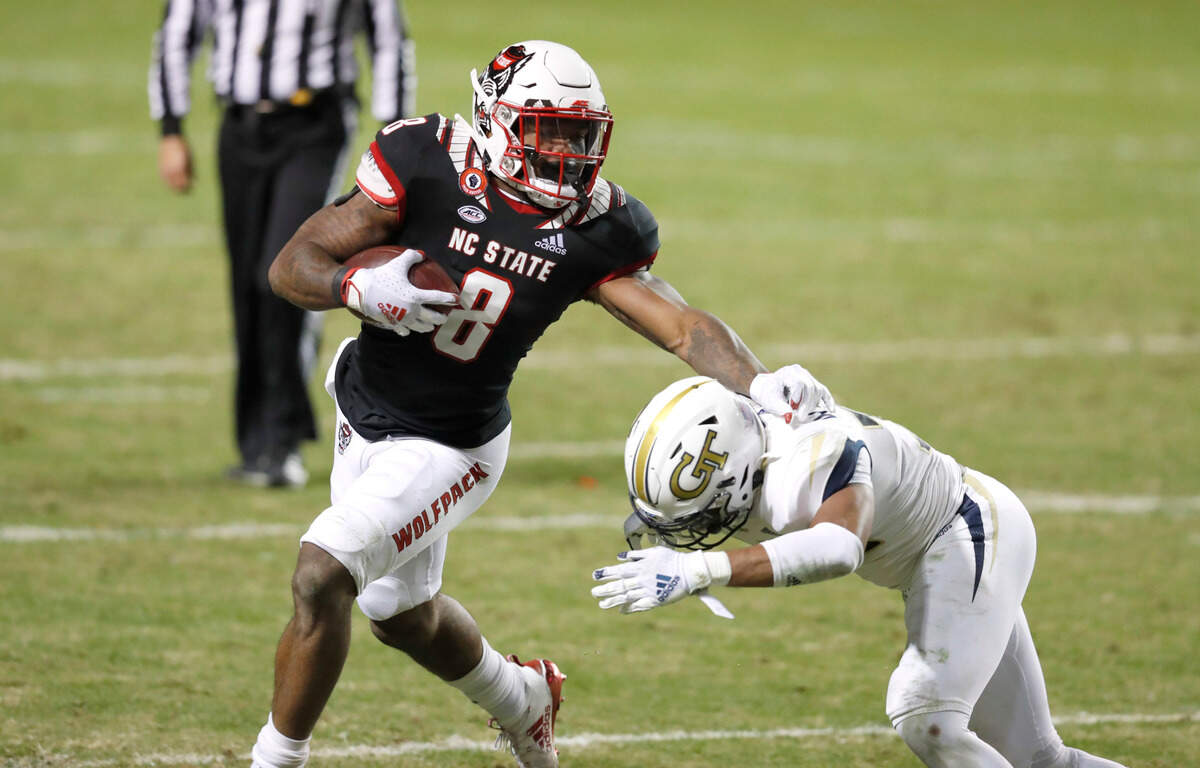 N.C. State running back Ricky Person Jr. (8) tries to keep Georgia Tech defensive back Wesley Walker (39) away during the second half of N.C. State’s 23-13 victory over Georgia Tech at Carter-Finley Stadium in Raleigh, N.C., Saturday, Dec. 5, 2020.