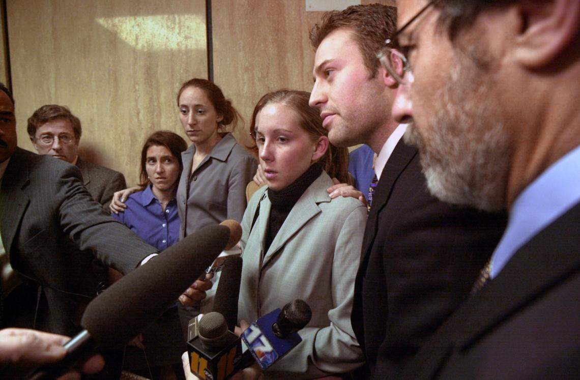 Kathleen Peterson’s daughter Caitlin Atwater (at center) speaks with the media with her step-brother Todd Peterson after Michael Peterson’s first court appearance.