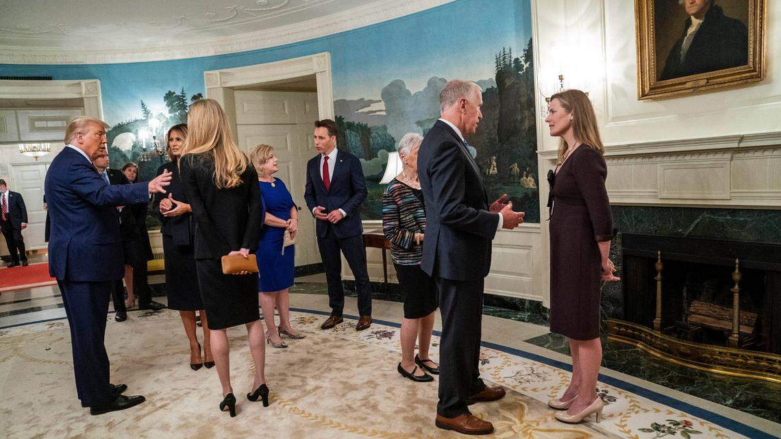 President Donald Trump and first lady Melania Trump with Sen. Kelly Loeffler (R-Ga.), left, and Sen. Thom Tillis (R-N.C.) with Judge Amy Coney Barrett, right, at a reception on the day of Barrett’s nomination inside the White House in Washington, Sept. 26, 2020. Sen. Josh Hawley (R-Mo.) is at center. Since the celebration for Barrett, at least seven attendees have tested positive for the virus.