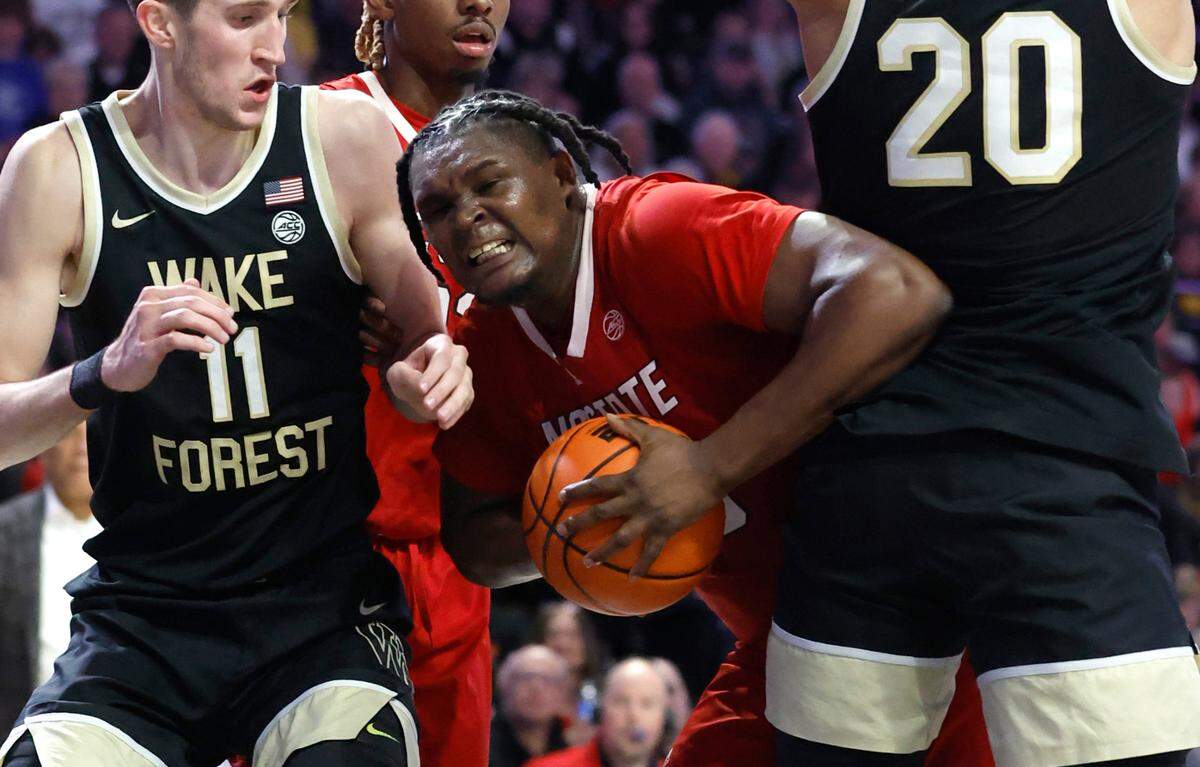 N.C. State’s D.J. Burns Jr. (30) works his way between Wake Forest’s Andrew Carr (11) and Wake Forest’s Davion Bradford (20) during the second half of N.C. State’s 79-77 victory over Wake Forest at Joel Coliseum in Winston-Salem, N.C., Saturday, Jan. 28, 2023.