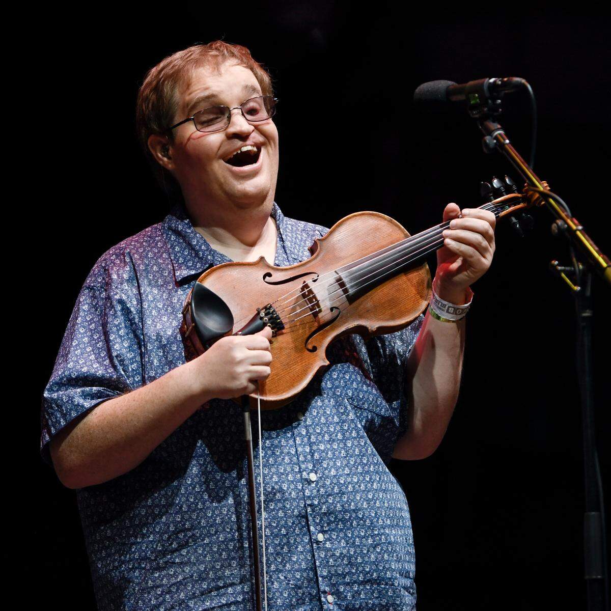 Fiddle player Michael Cleveland smiles as the crowd cheers one of the songs from the Bela Fleck’s “My Bluegrass Heart” at IBMA Bluegrass Live! at Raleigh, N.C.’s Red Hat Amphitheater, Friday night, Oct. 1, 2021.