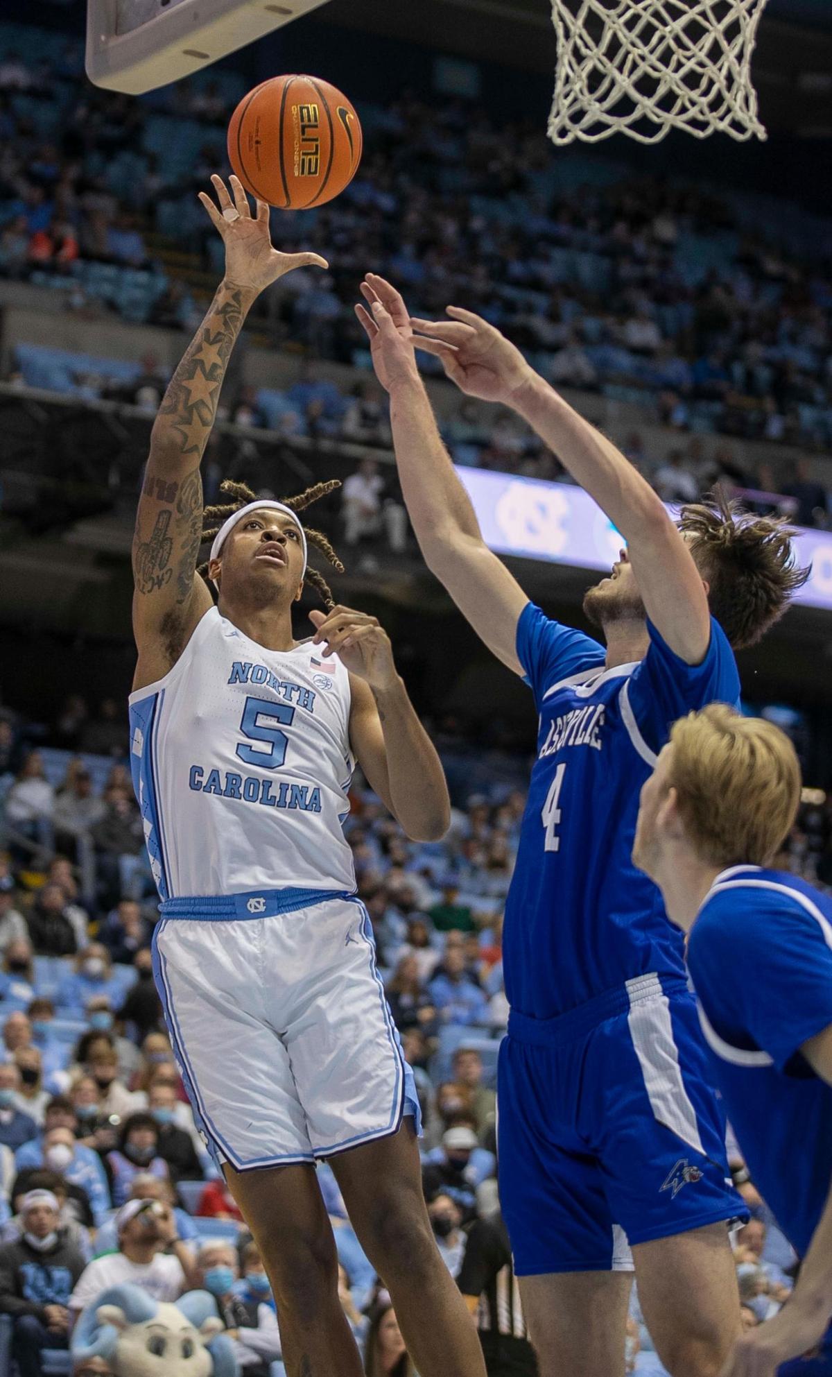 North Carolina’s Armando Bacot (5) puts up a shot against UNC-Asheville’s Drew Pember (4) in the first half on Tuesday, November 23, 2021 at the Smith Center in Chapel Hill, N.C. Bacot lead all scores with 22 points in the Tar Heels’ 72-53 victory.
