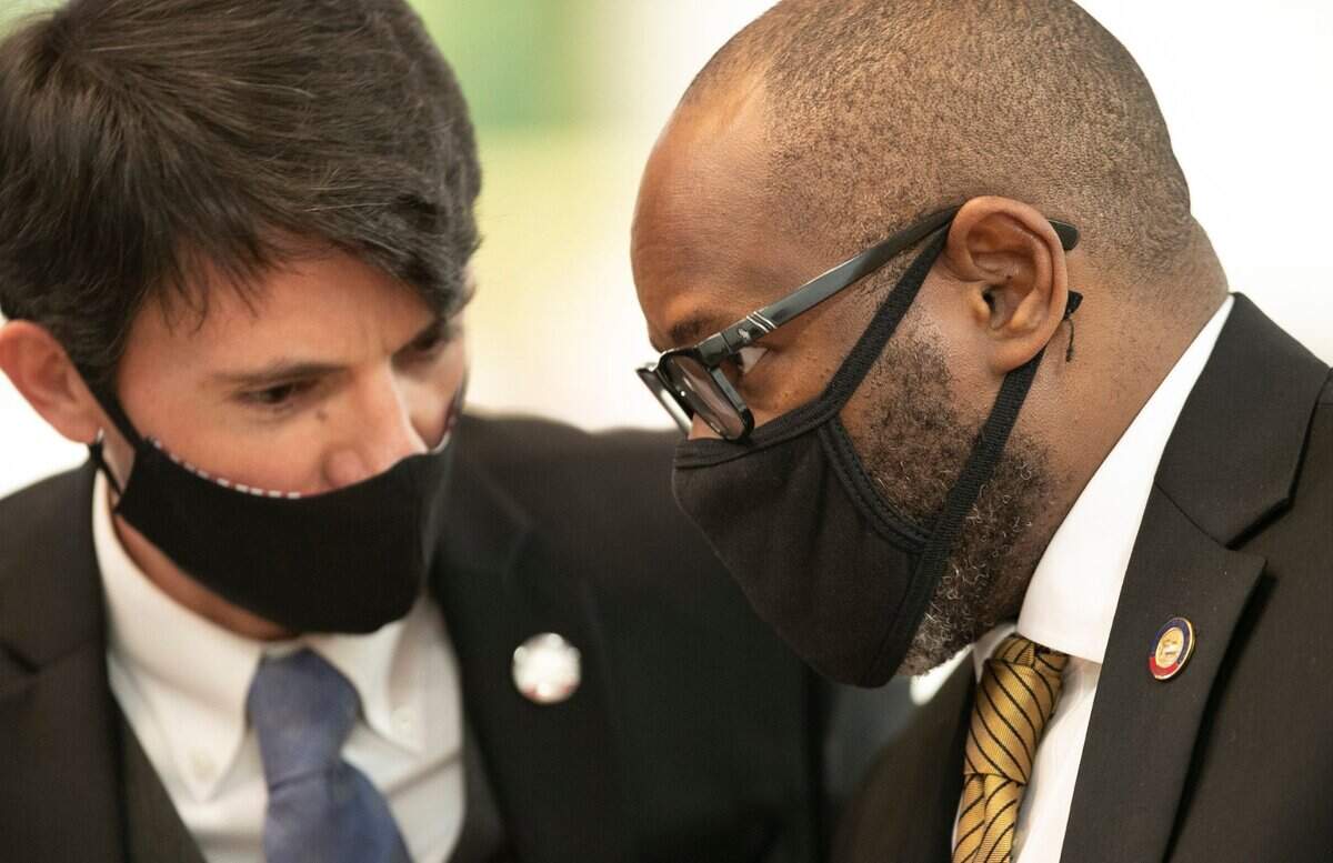 Rep. Jon Hardister, left, talks with Rep. Amos Quick III, during the House session on Wednesday, January 27, 2021 in Raleigh N.C. Both represent Guilford County.