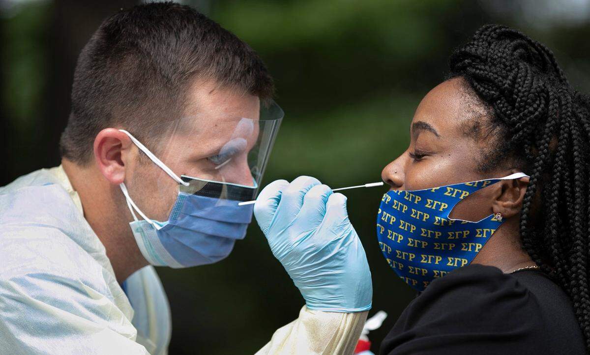 A technician from UNC Health takes a COVID-19 test sample from a client at Robert’s Park on Martin Street on Monday, September 8, 2020 in Raleigh, N.C.