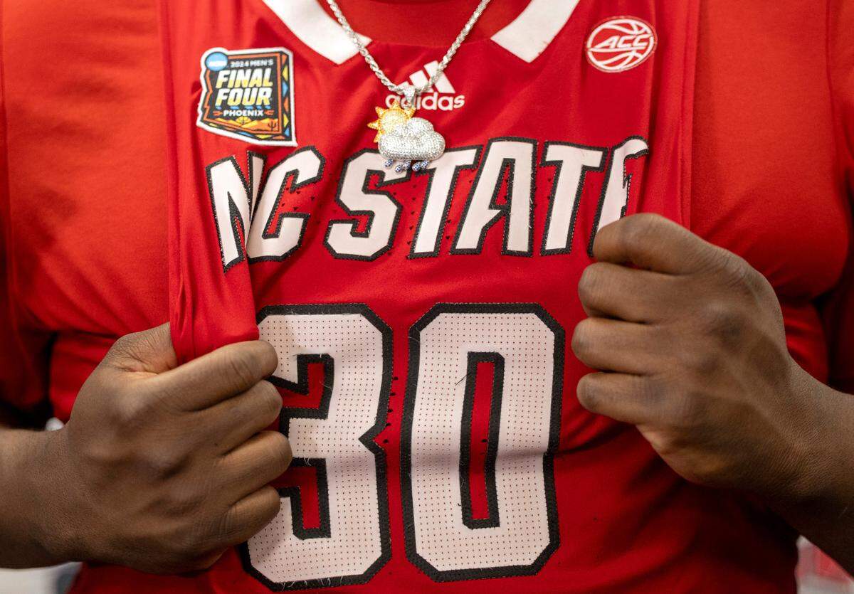 N.C. State’s D.J. Burns Jr. (30) grasps his jersey as he takes questions from the media following the Wolfpack’s loss to Purdue in the NCAA Final Four National Semifinal game on Saturday, April 6, 2024 at State Farm Stadium in Glendale, AZ.