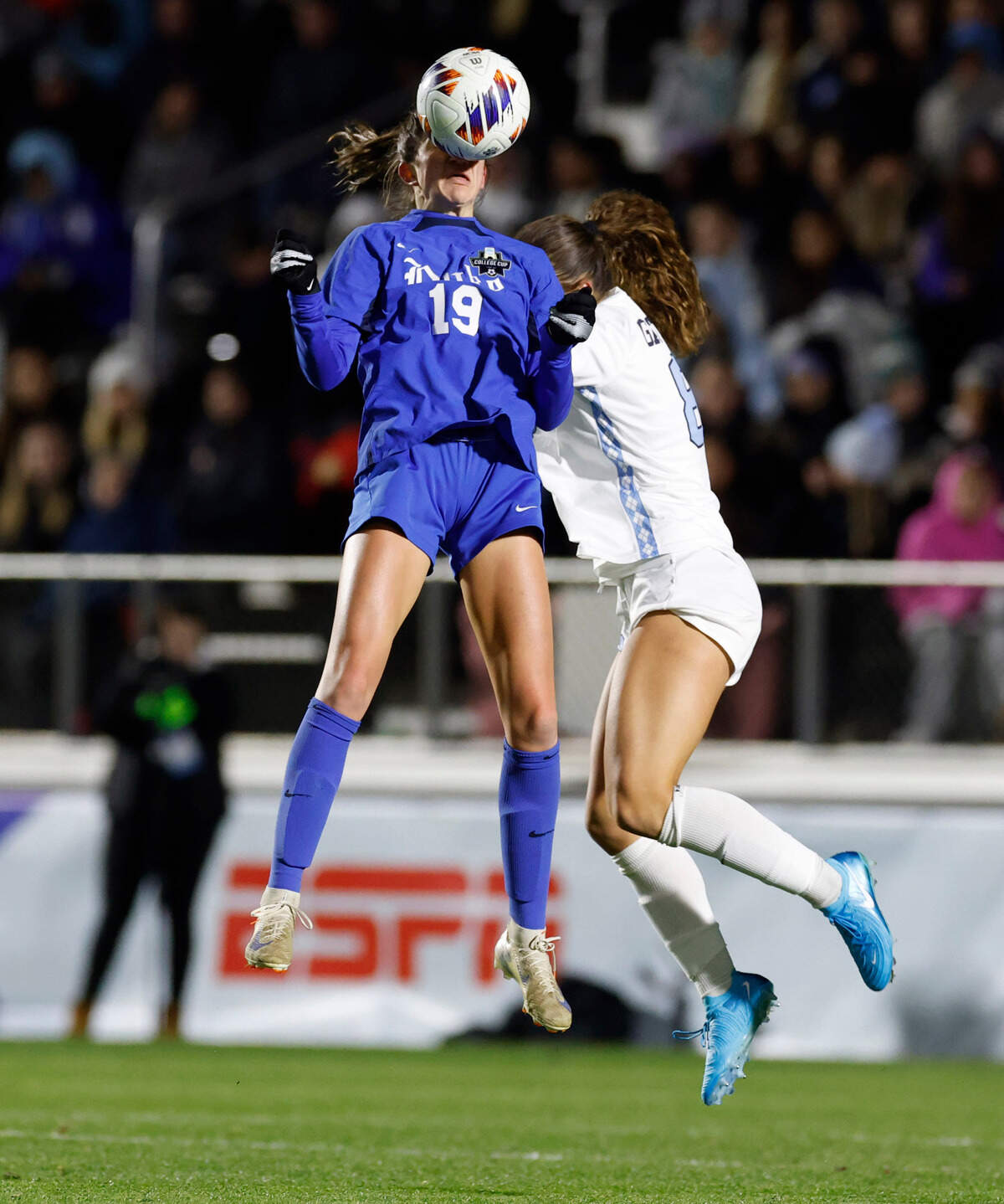 Duke’s Maggie Graham (19) heads the ball in front of North Carolina’s Bella Gaetino (8) during the first half of UNC’s game against Duke in the semifinals of the 2024 Women’s College Cup at WakeMed Soccer Park in Cary, N.C., Friday, Dec. 6, 2024.
