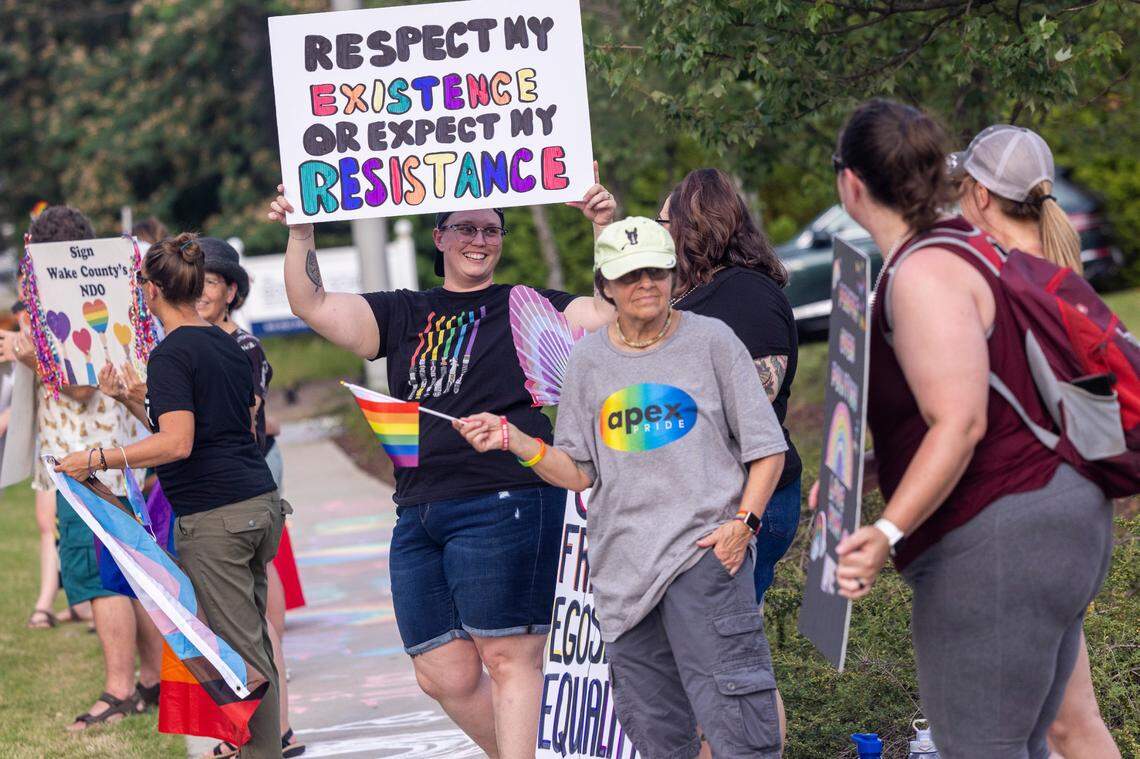 About 50 demonstrators rally outside the Holly Springs Law Enforcement Center to urge the town council to sign a Pride Month proclamation and adopt a non-discrimination ordinance. Holly Springs Mayor Sean Mayefskie refused to sign the proclamation. He said then that the town already has “diverse and inclusive” policies.