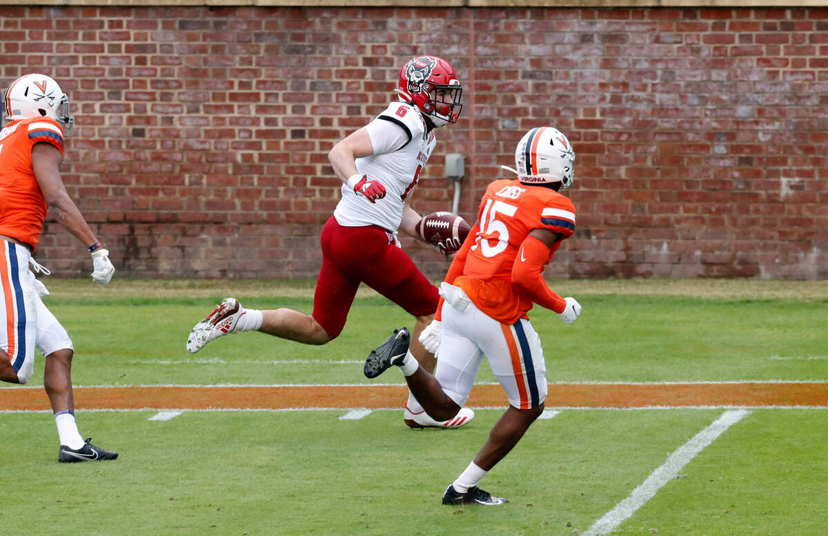 N.C. State tight end Cary Angeline (6) beats Virginia safety De’Vante Cross (15) while scoring on a 32-yard touchdown reception during the first half of N.C. State’s game against Virginia at Scott Stadium in Charlottesville, Va., Saturday, Oct. 10, 2020.