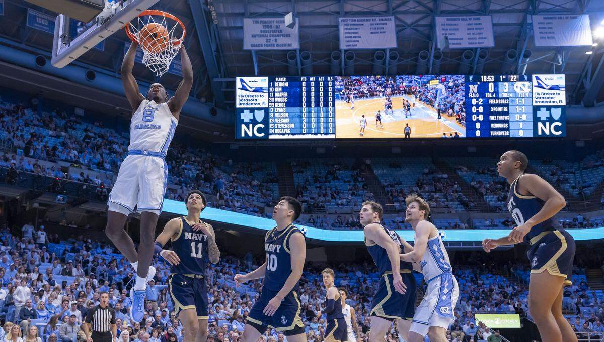 North Carolina forward Caleb Wilson (8) dunks over Navy forward Donovan Draper (11) and Jinwoo Kim (10) in the first half on Tuesday, November 18, 2025 at the Smith Center in Chapel Hill, N.C.  Wilson lead all scores with 23 points. 
