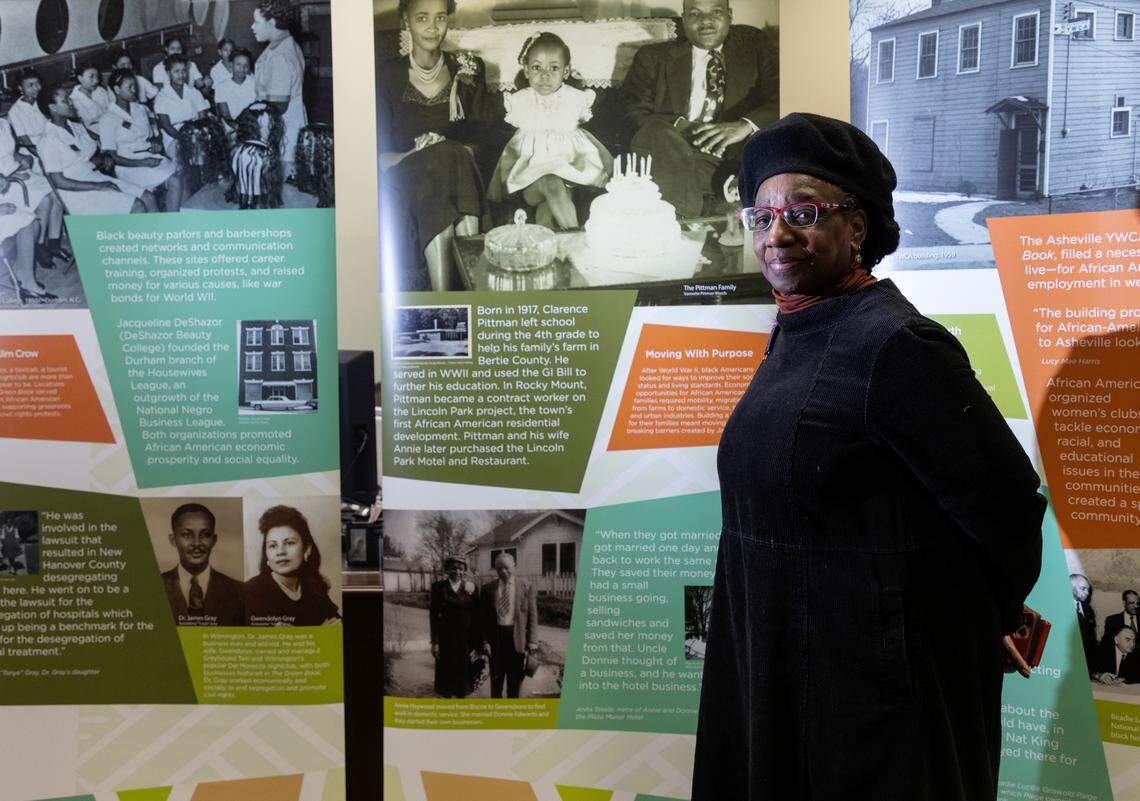 Jereann Johnson is photographed on Thursday, Feb. 2, 2023, next to an exhibit about the Green Book on display at Warren County Memorial Library in Warrenton, N.C. The Green Book, published from 1936 to 1966, listed motels, restaurants and other businesses where Black travelers were safe to stop. Johnson says the Green Book is a reflection of the strength of the Black community. “The whole experience was an act of genius — in spite of all the barriers, Black people were able to prosper and survive and thrive.”