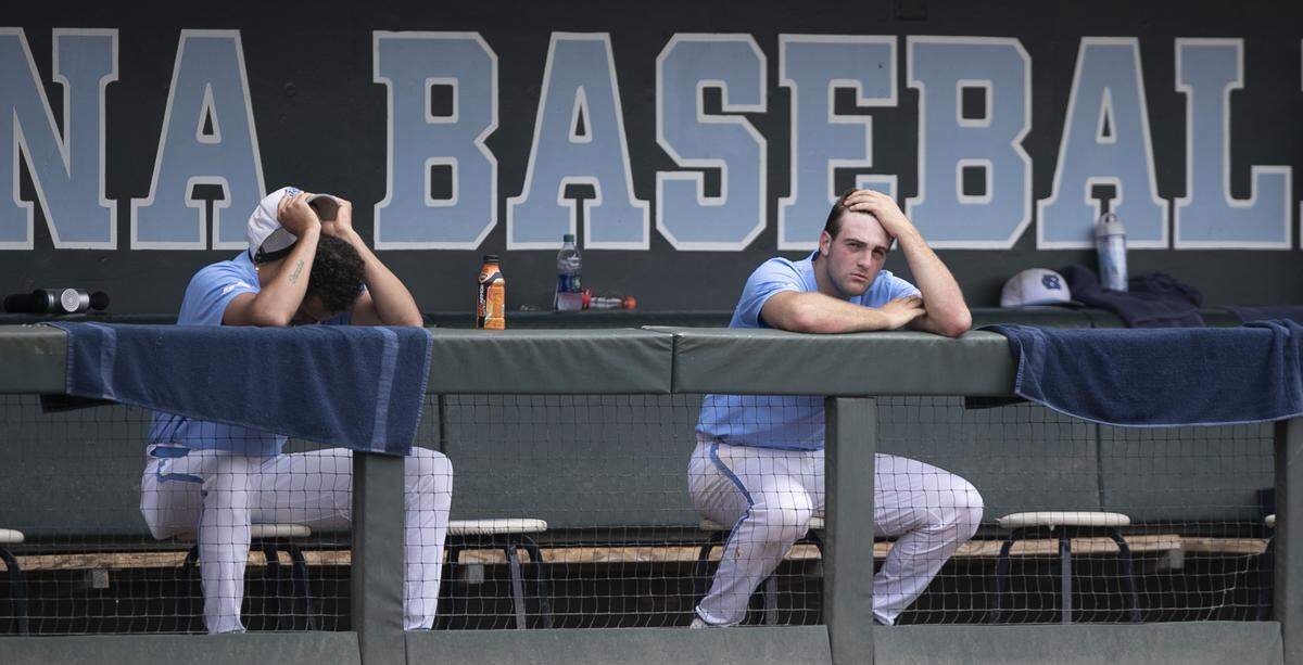 North Carolina pitchers Austin Bergner (45), left, and Connor Ollio (48) watch the top of the first inning from the Tar Heels’ dugout as Auburn scored 13 runs on nine hits to take control of the NCAA Super Regional on Monday, June 10, 2019 at Boshamer Stadium in Chapel Hill, N.C. Ollio was one of four pitchers to work in the first inning against Auburn.