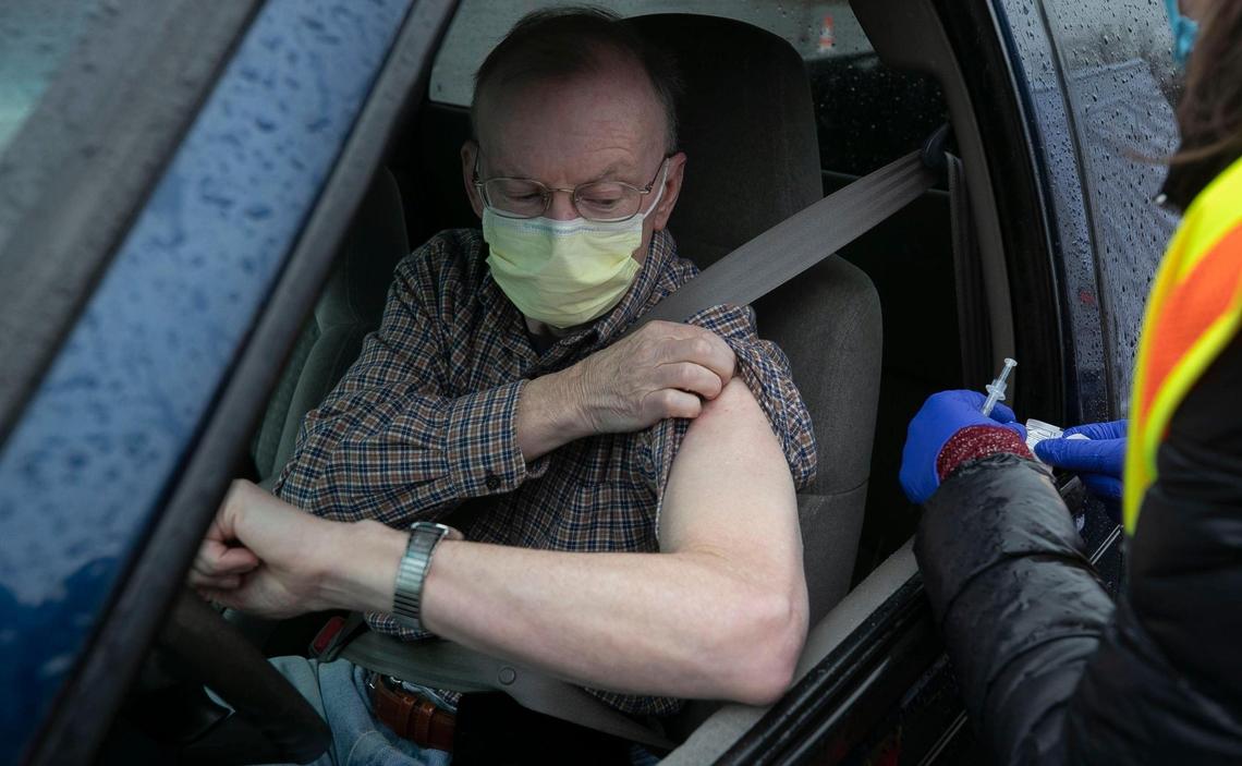 Ken Godsey rolls up his sleeve to receive the COVID-19 vaccine during a Wake County mass vaccination clinic on Thursday, February 11, 2021 at PNC Arena in Raleigh, N.C. Wake County Public Health is collaborating with area hospitals and a consortium of providers for the three day appointment only drive-thru clinic.