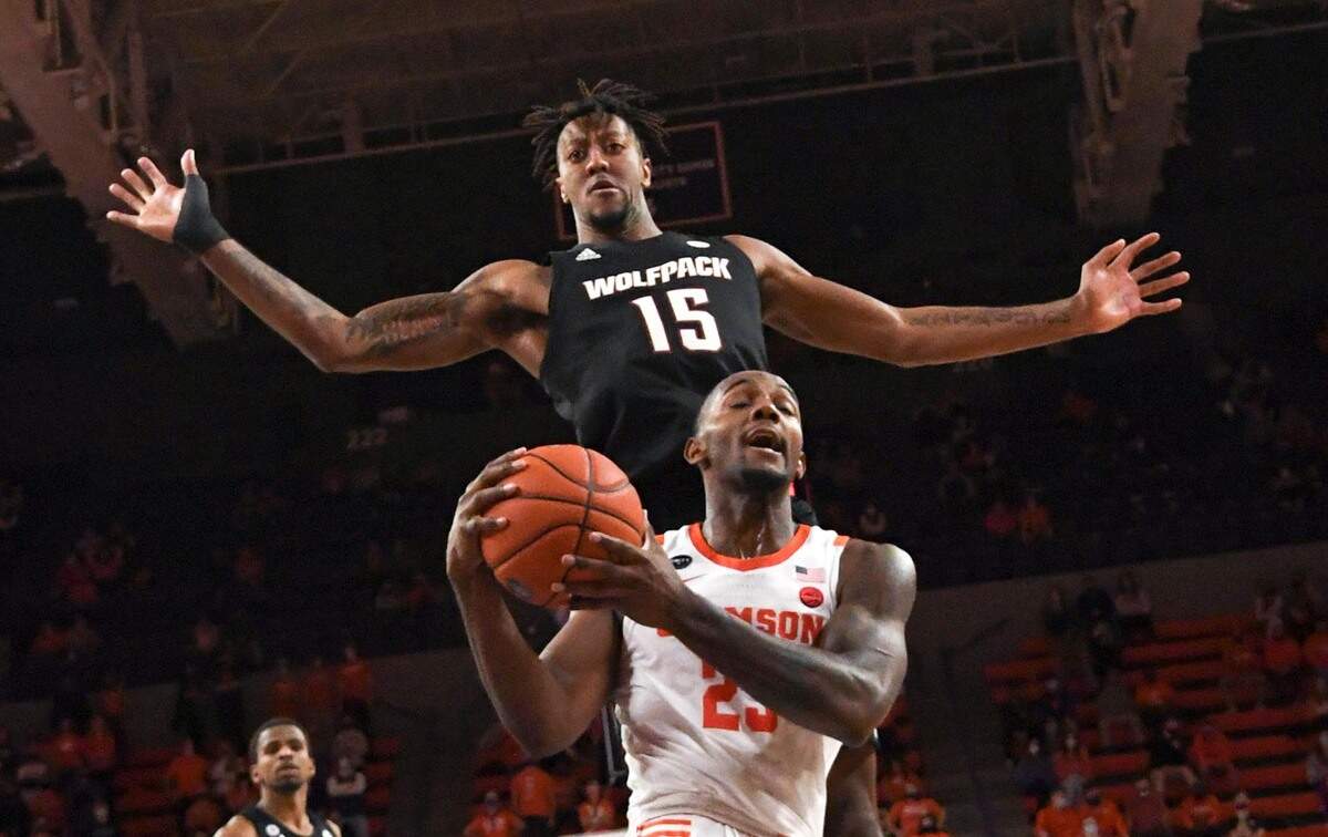 NC State forward Manny Bates(15) pressures Clemson senior forward Aamir Simms(25) during the second half of their game on January 5, 2021.