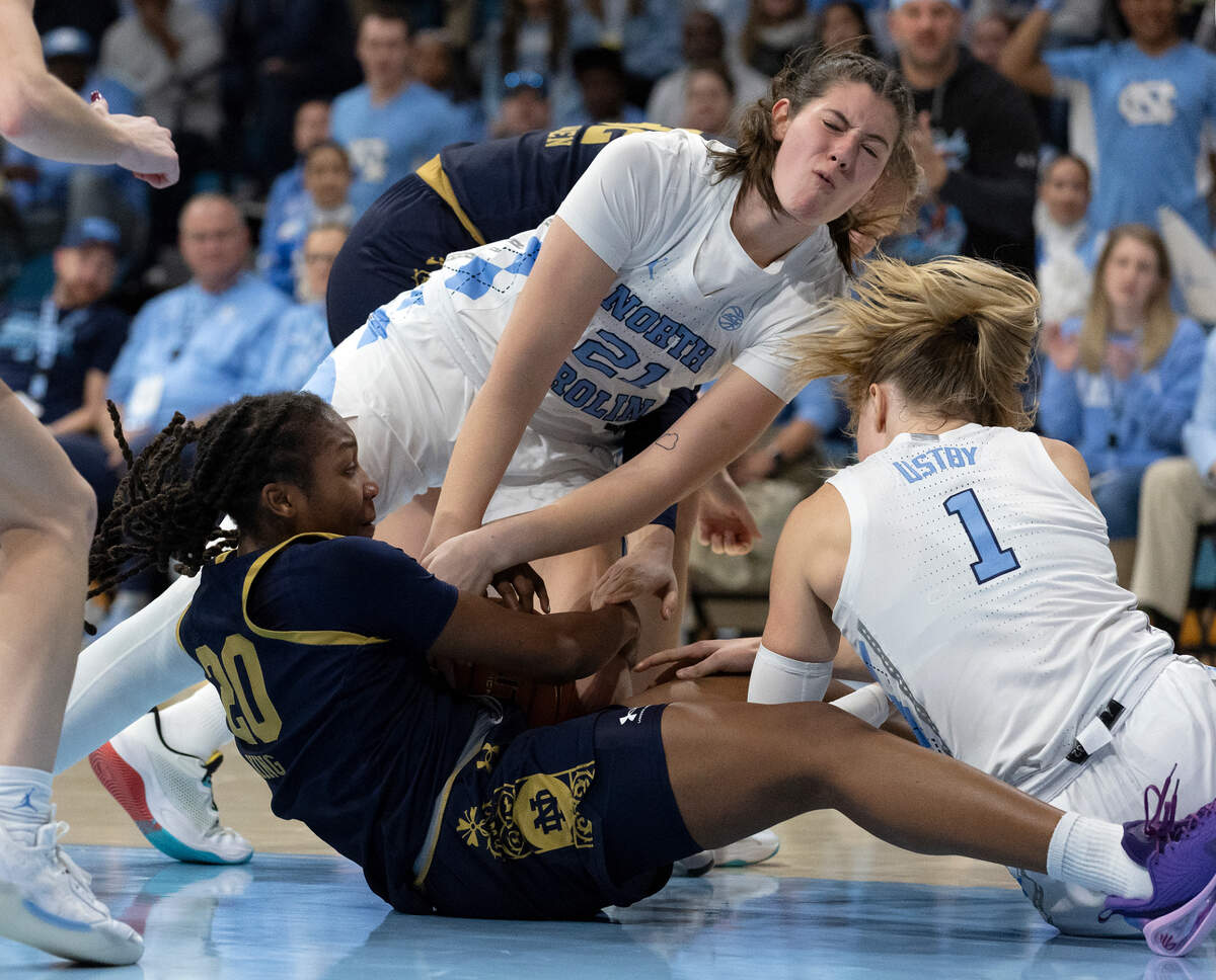 North Carolina’s Ciera Toomey and Alyssa Ustby tangle with Notre Dame’s Liatu King for a loose ball during the second half of the Tar Heels’ 76-66 loss on Sunday, Jan. 5, 2025, at Carmichael Arena in Chapel Hill, N.C.