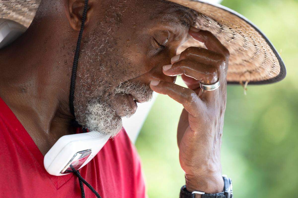 Kenneth Jeffreys takes a break while working on detailing a car at Peter’s Hand Car Wash on Capital Blvd in Raleigh, N.C., Thursday, July 27, 2023. “Man, it’s hot. It’s hot” said Jeffreys. “It’s so hot it makes me dizzy.”
