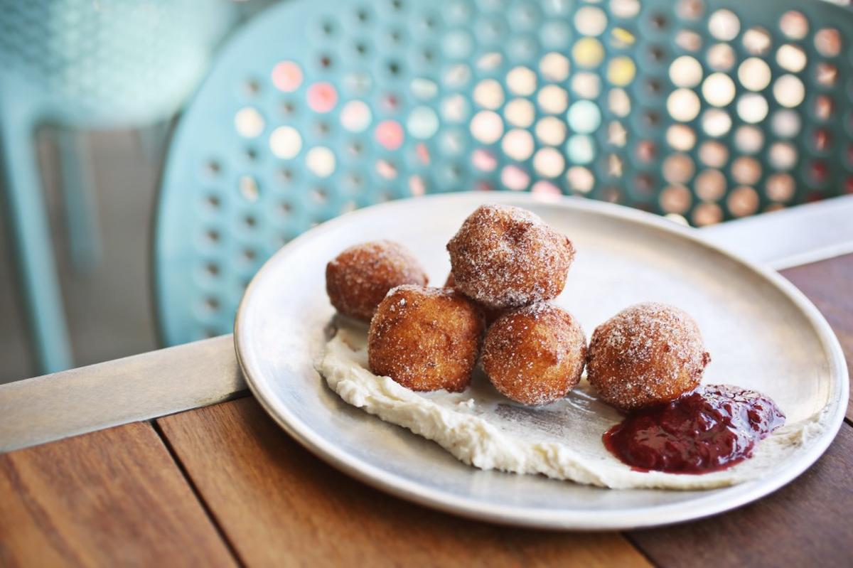 The sugar-dusted ricotta fritters at Hummingbird are nestled on a cloud of mascarpone.