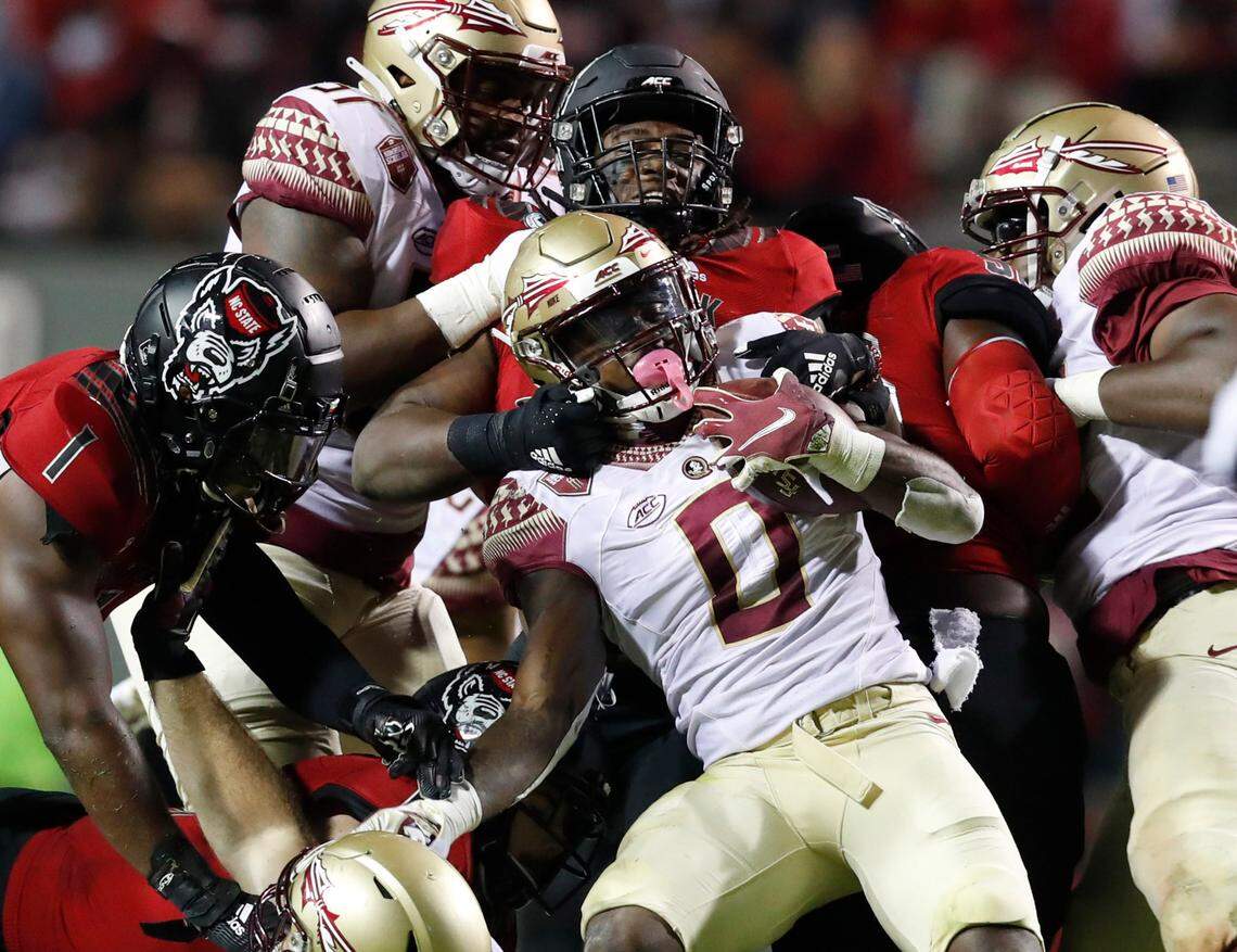 N.C. State defensive end Terrell Dawkins (0) stops Florida State running back Jashaun Corbin (0) during the first half of N.C. State’s game against Florida State at Carter-Finley Stadium in Raleigh, N.C., Saturday, Nov. 14, 2020.