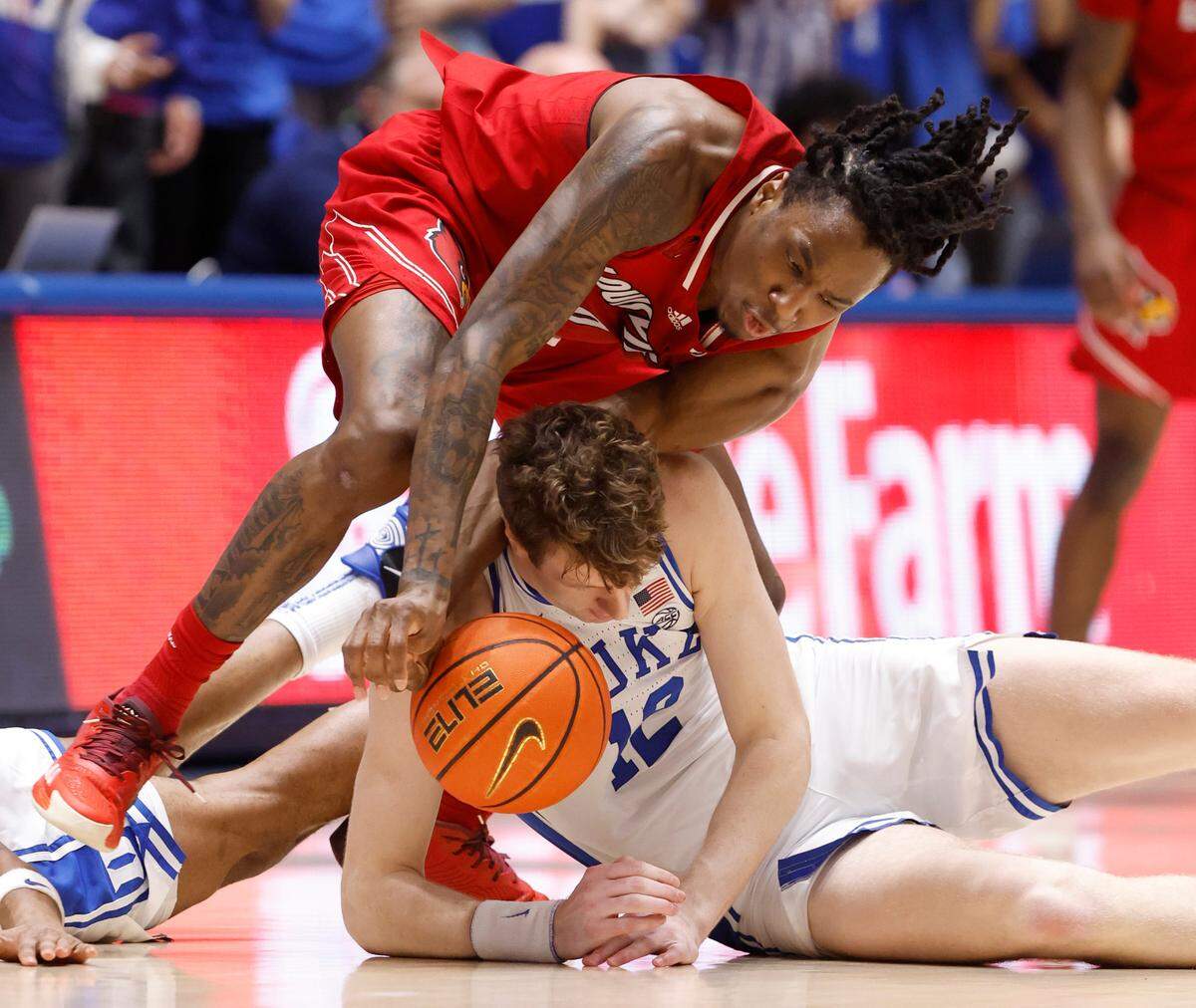 Duke’s TJ Power (12) battles for the loose ball with Louisville’s Mike James (0) during the second half of Duke’s 84-59 victory over Louisville at Cameron Indoor Stadium in Durham, N.C., Wednesday, Feb. 28, 2024.