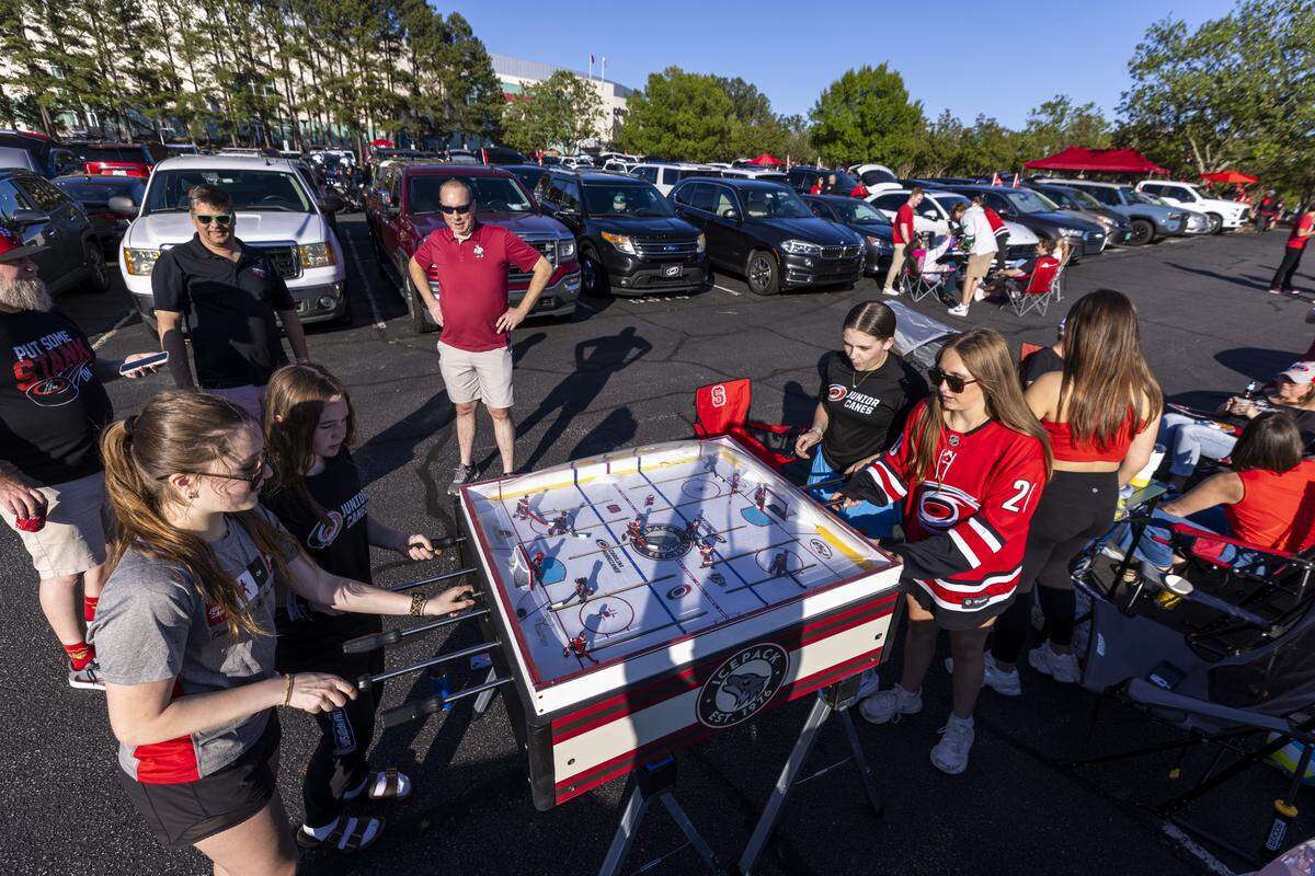 Carolina Hurricanes fans tailgate in the parking lot at the Lenovo Center in Raleigh on Tuesday, June 2, 2026, before Game 1 of the Stanley Cup Final. For the first time since 2006, the Hurricanes are playing in the Stanley Cup Final, facing the Vegas Golden Knights, who won the Stanley Cup in 2023.