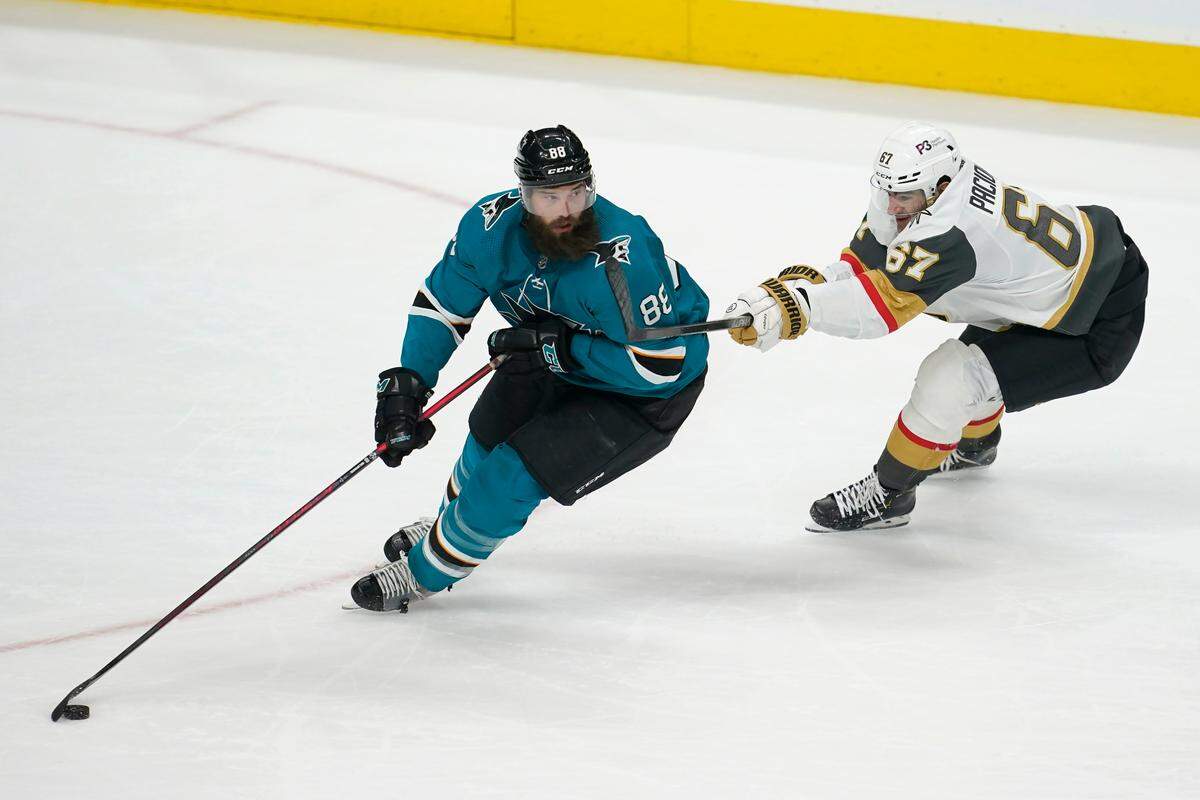 San Jose Sharks defenseman Brent Burns (88) skates with the puck against Vegas Golden Knights left wing Max Pacioretty (67) during the third period of an NHL hockey game in San Jose, Calif., Sunday, Feb. 20, 2022. (AP Photo/Jeff Chiu)