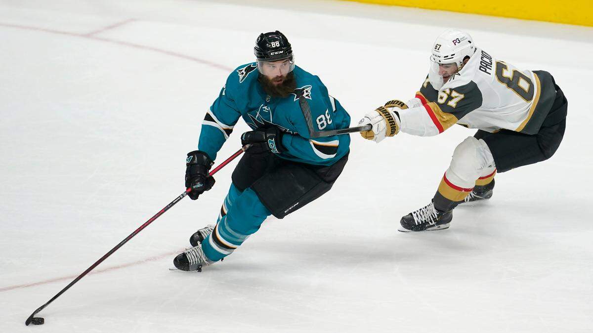 San Jose Sharks defenseman Brent Burns (88) skates with the puck against Vegas Golden Knights left wing Max Pacioretty (67) during the third period of an NHL hockey game in San Jose, Calif., Sunday, Feb. 20, 2022. (AP Photo/Jeff Chiu)