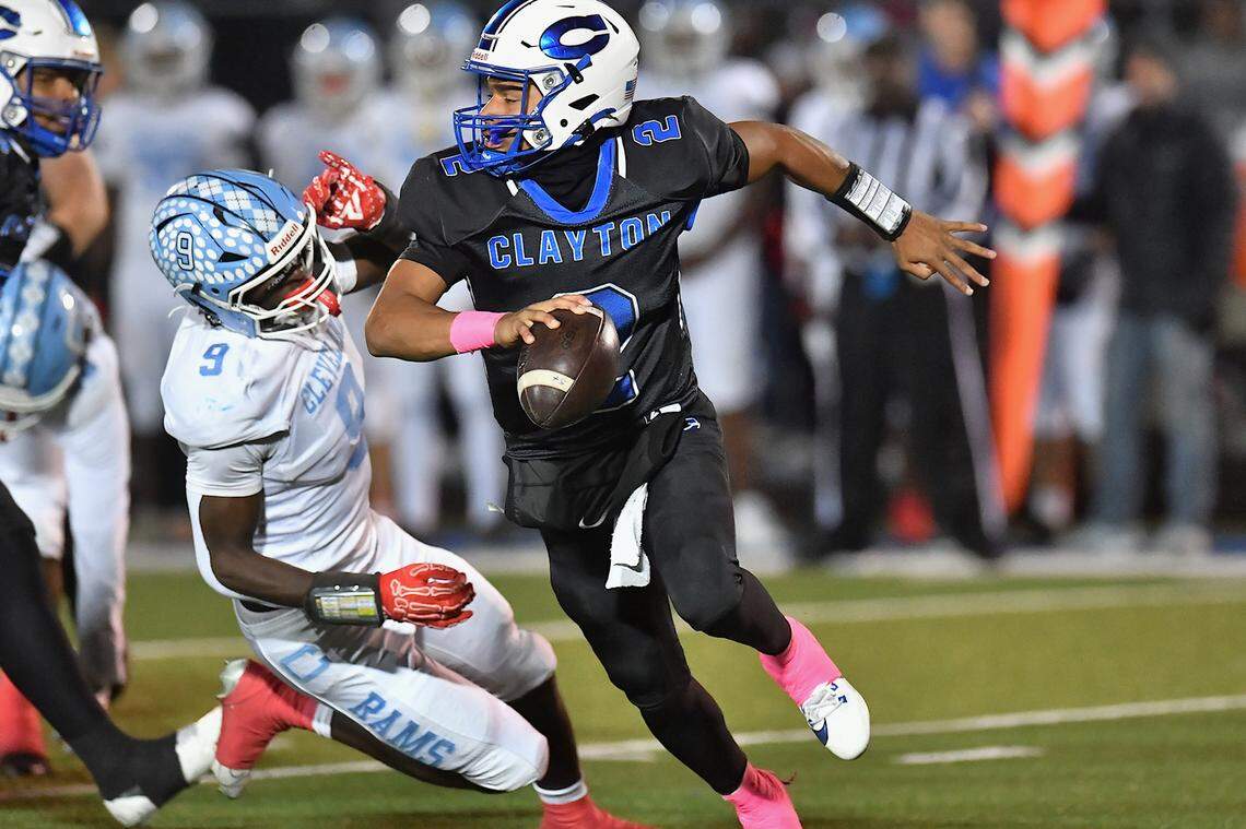 Clayton quarterback Aiden Smalls scrambles for yards against Cleveland's Jaylen King (9) during the second half . The Cleveland Rams took on the Clayton Comets in a conference football game in Clayton, N.C. on October 31st in Clayton, N.C.
