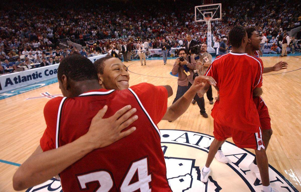 NC State's Anthony Grundy celebrates with Julius Hodge after the Wolfpack upset Maryland 86-82 in semifinal action at the ACC Tournament Saturday, March 9, 2002.  