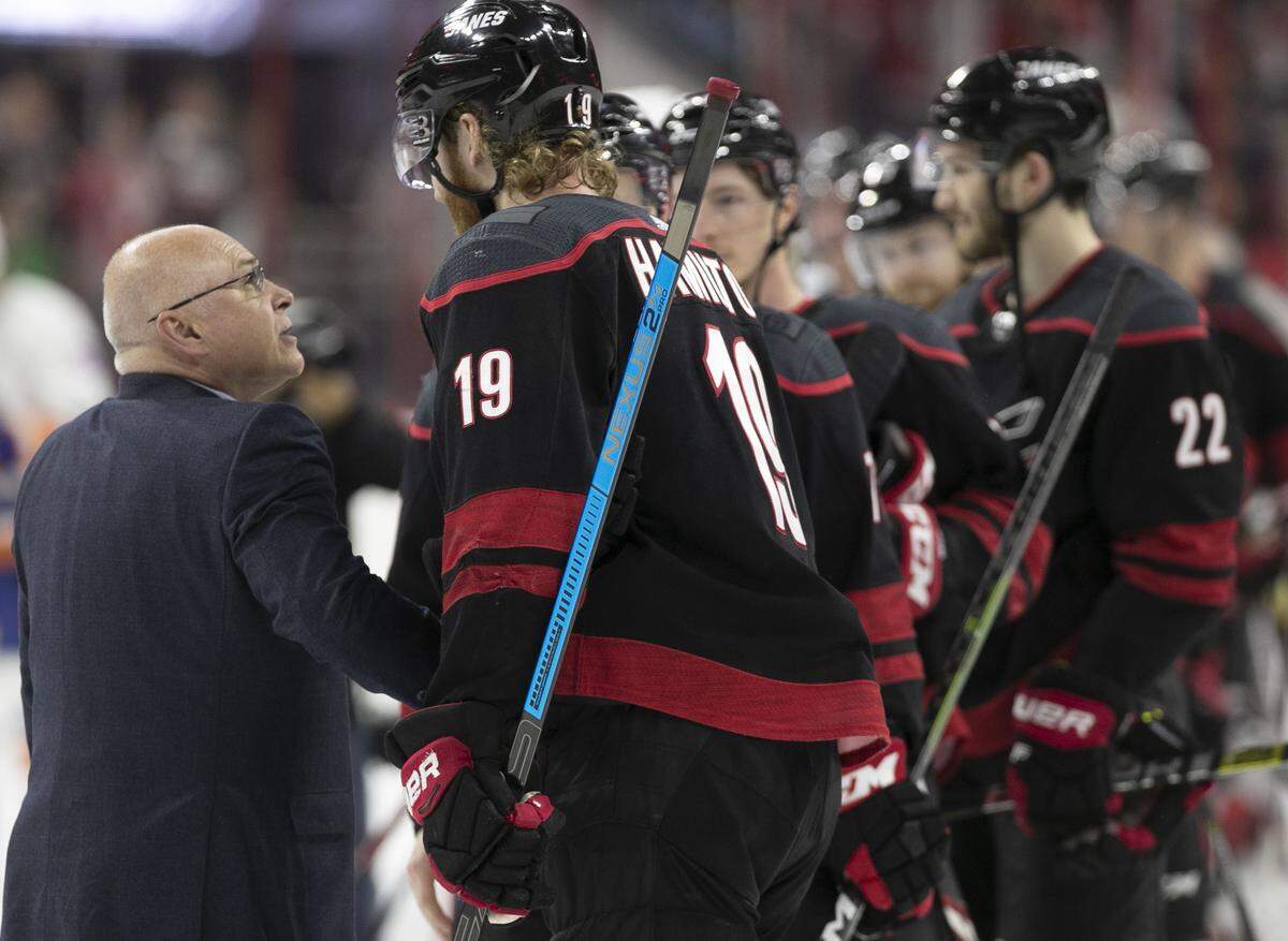New York Islander coach Barry Trotz congratulates Carolina Hurricanes’ Dougie Hamilton (19) after the Hurricanes rolled to a 5-2 victory and clinched their series on Friday, May 3, 2019 at PNC Arena in Raleigh, N.
