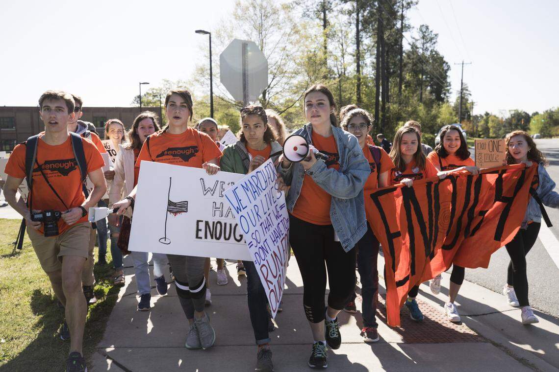 East Chapel Hill High School students walk away from their campus just before 10 a.m. on April 20, 2018  and begin their 4.6 mile march to Franklin St.'s Peace and Justice Plaza for an anti-gun violence rally. Students at Chapel Hill High School, Carrboro High School, and Phillips Middle School also walked out and marched or carpooled to the rally. 
