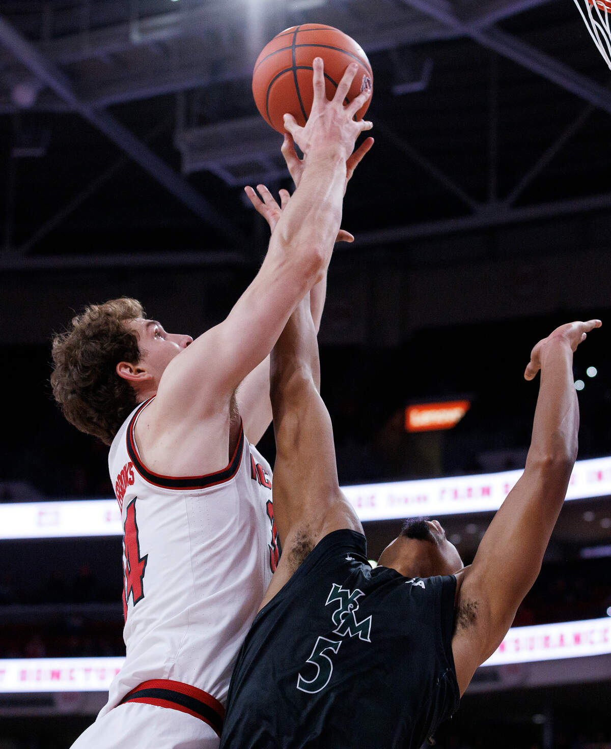 N.C. State’s Ben Middlebrooks grabs a rebound over William & Mary’s Noah Collier during the first half of the Wolfpack’s 84-61 win at Lenovo Center on Friday, Nov. 22, 2024, in Raleigh, N.C.