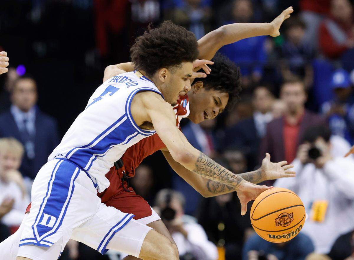 Duke’s Tyrese Proctor (5) drives by Alabama’s Aden Holloway (2) during the first half of Duke’s game against Alabama in their Elite 8 game in the 2025 NCAA Men’s Basketball Championship at the Prudential Center in Newark, N.J., Saturday, March 29, 2025.
