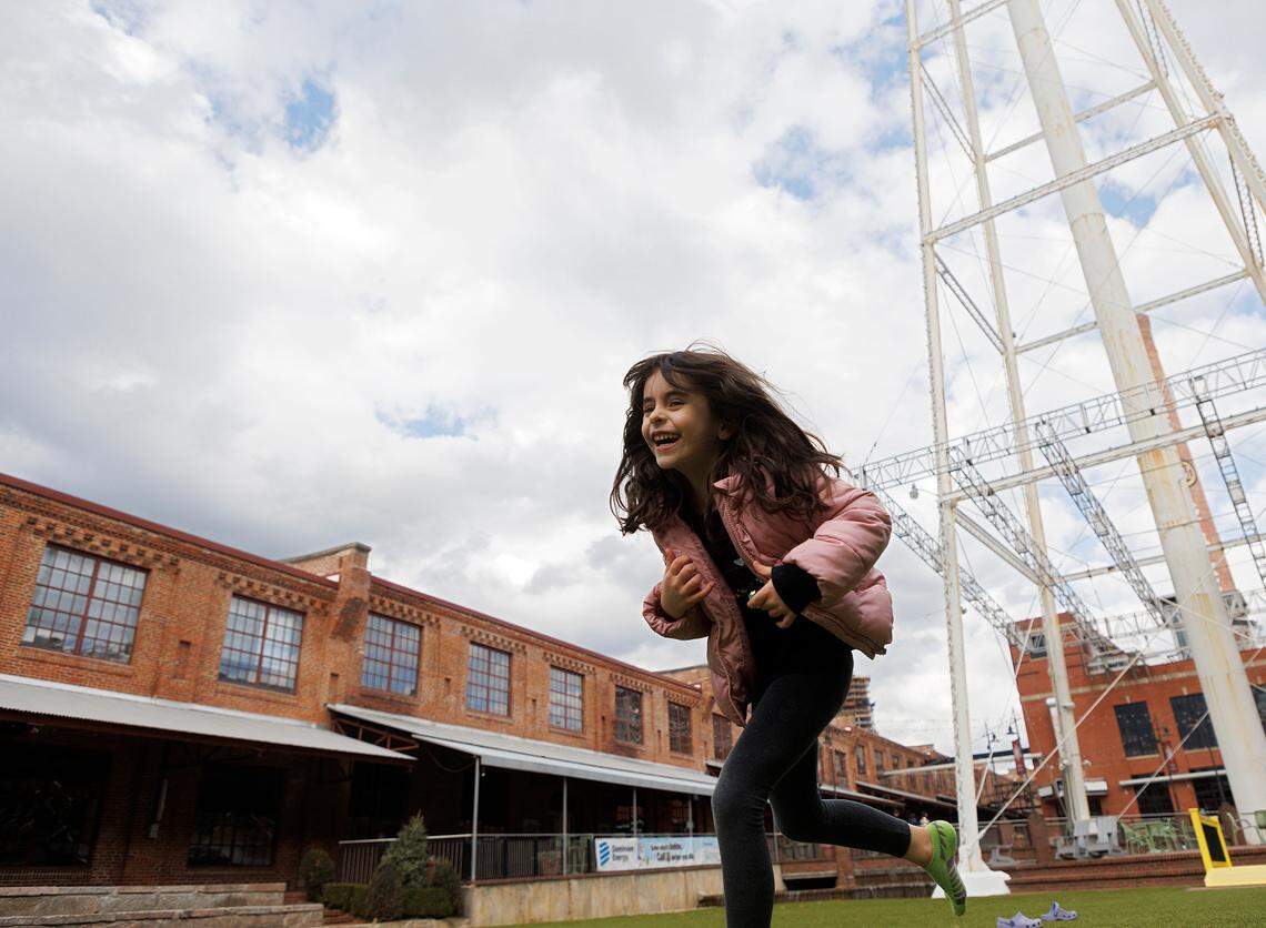 Isabel Leary, 6, smiles while playing with family at the American Tobacco campus on Friday, Dec. 29, 2023, in Durham, N.C.