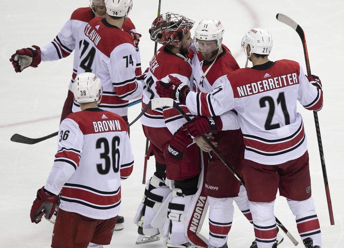 Carolina Hurricanes’ surround goalie Petr Mrazek (34) after defeating the Washington Capitals 4-3 to clinch their series on Wednesday, April 24, 2019 at Capital One Arena in Washington, D.C.
