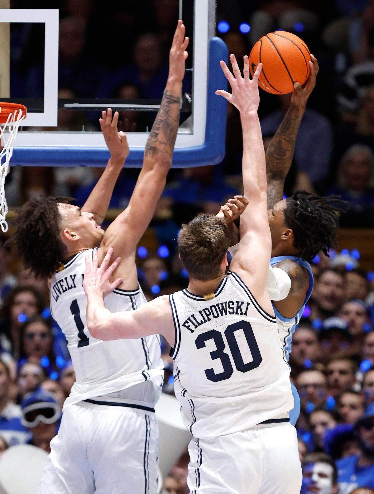Duke’s Dereck Lively II (1) prepares to block the shot by North Carolina’s Caleb Love (2) during the second half of Duke’s 63-57 victory over UNC at Cameron Indoor Stadium in Durham, N.C., Saturday, Feb. 4, 2023.