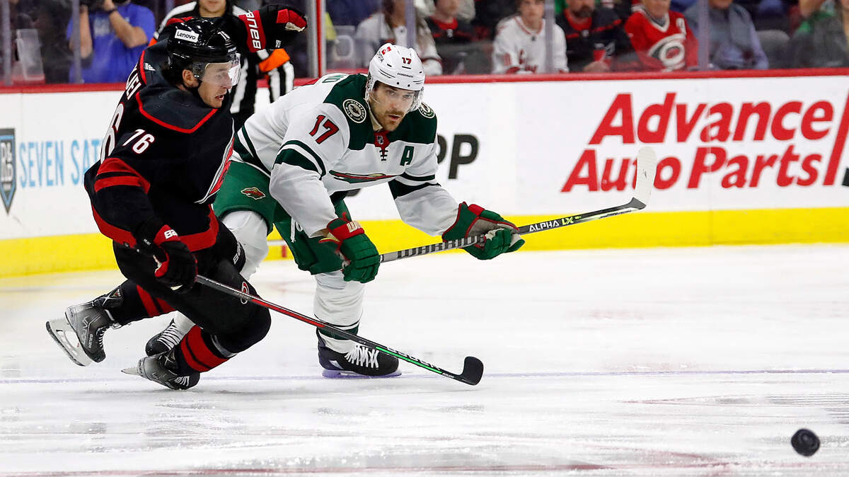 Minnesota Wild’s Marcus Foligno (17) knocks Carolina Hurricanes’ Brady Skjei (76) off the puck during the first period of an NHL hockey game in Raleigh, N.C., Saturday, April 2, 2022. (AP Photo/Karl B DeBlaker)
