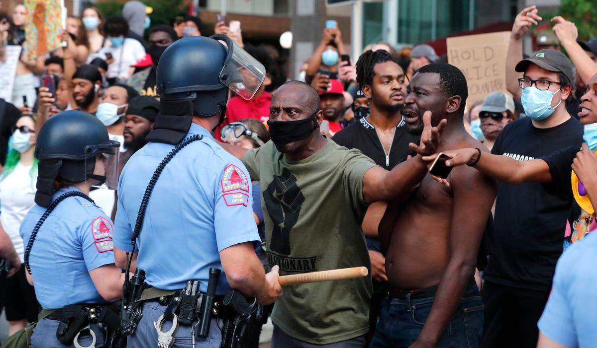 Demonstrators stand off with police during a protest in downtown Raleigh, N.C. Saturday, May 30, 2020.