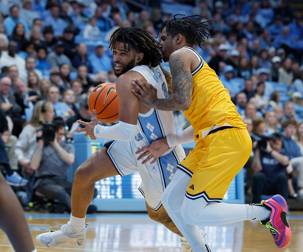 North Carolina’s RJ Davis pushes the ball past La Salle’s Corey McKeithan during the first half of the Tar Heels’ 93-67 win on Saturday, Dec. 14, 2024, at the Smith Center in Chapel Hill, N.C.