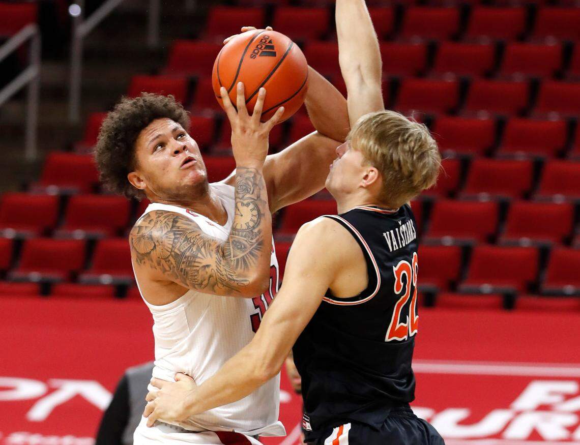 N.C. State’s Nick Farrar (30) looks to shoot as Campbell’s Laurynas Vaitaras (22) defends during the second half of N.C. State’s 69-50 victory over Campbell at PNC Arena in Raleigh, N.C., Saturday, Dec. 19, 2020.