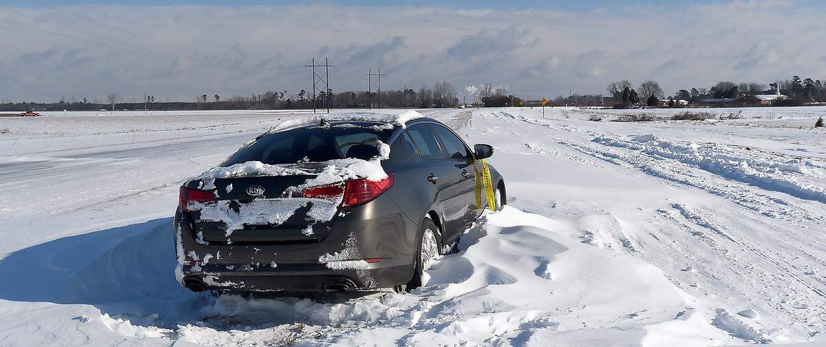 An abandoned car sits in the Hwy 64 median near Plymouth, N.C. on Jan.4, 2018. A winter storm paralyzed eastern North Carolina and made travel treacherous throughout the region.