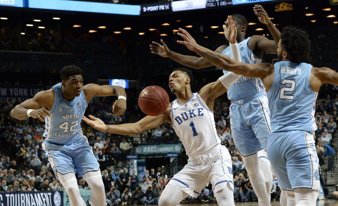 Duke Trevon Duval (1) loses the ball as UNC defenders converge on him in the first half.