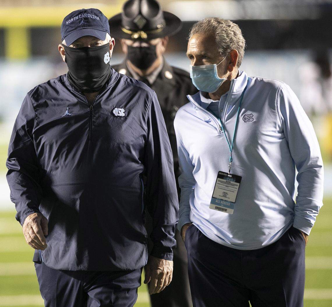 North Carolina coach Mack Brown and athletic director Bubba Cunningham leave the field together following the Tar Heels’ 31-17 loss to Notre Dame on Friday, November 27, 2020 at Kenan Stadium in Chapel Hill, N.C.