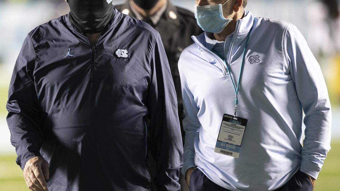 North Carolina coach Mack Brown and athletic director Bubba Cunningham leave the field together following the Tar Heels’ 31-17 loss to Notre Dame on Friday, November 27, 2020 at Kenan Stadium in Chapel Hill, N.C.